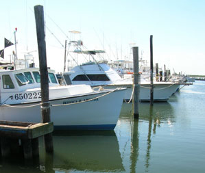 boats in inlet near lighthouse